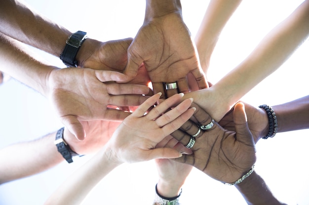 Bottom view people putting hands together