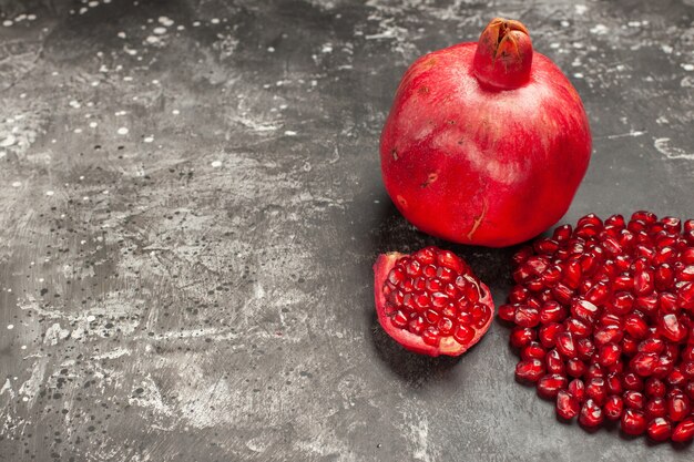 Bottom view pomegranate pomegranate seeds on dark table with free space