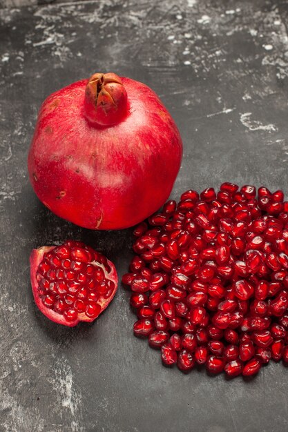 Bottom view pomegranate pomegranate seeds on dark table