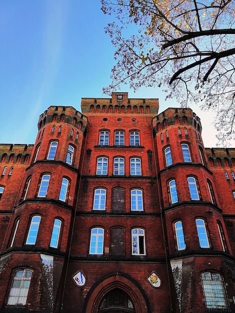 Free photo bottom view shot of a red brick building in stargard, poland.