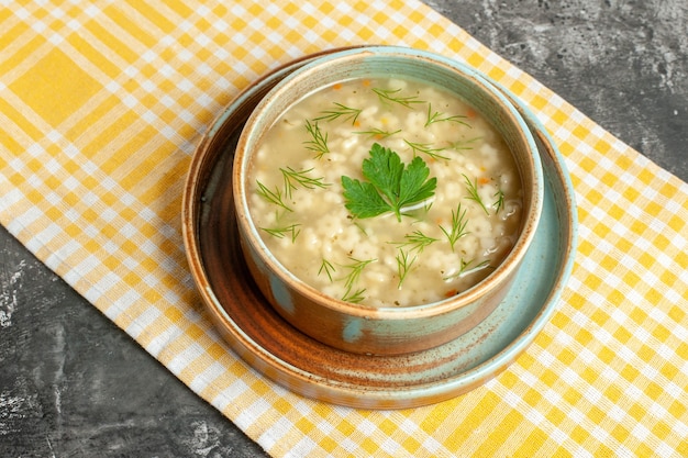 Free Photo bottom view star soup in bowl on yellow tablecloth on dark background