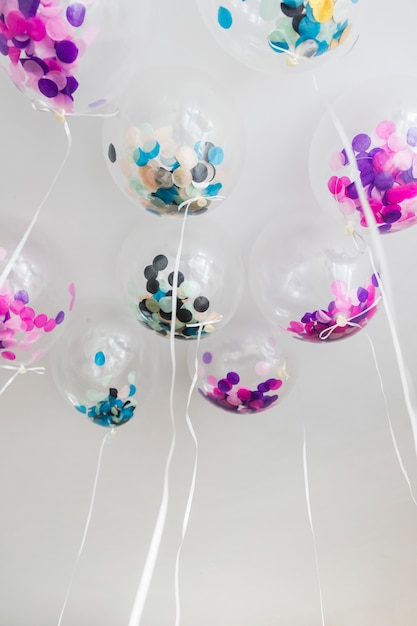 Free photo bottom view transparent balloons with confetti inside