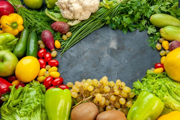 Bottom view vegetables and fruits cumcuat lettuce zucchini bell peppers kiwi grapes parsley green onion cauliflower cherry tomatoes lemon free space