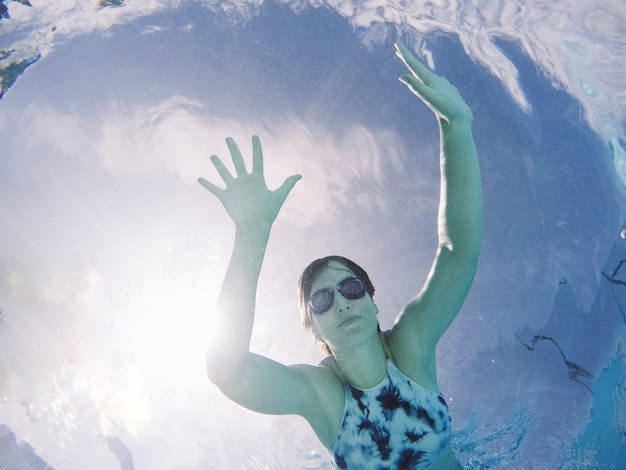 Free photo bottom view of woman diving in pool