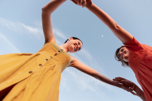 Bottom view women dancing outdoors