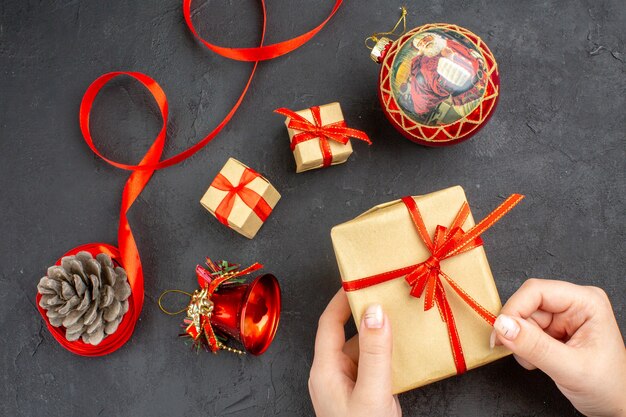 Bottom view xmas gifts in brown paper ribbon xmas tree toys on newspaper on beige