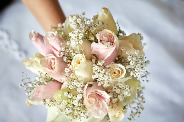 Bouquet of the beautiful pink and white wedding roses with a diamond ring