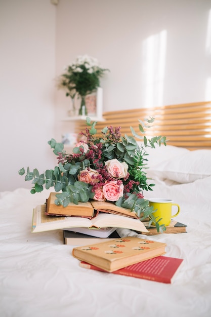 Bouquet and books on bed