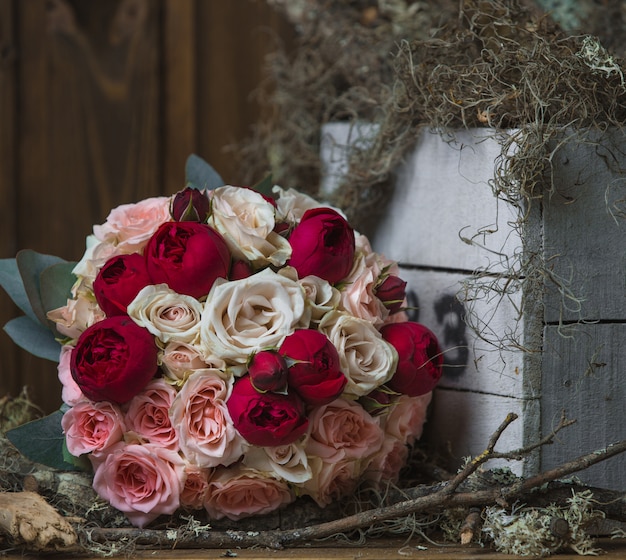 Free photo bouquet of deep and light pink peonies standing on the door