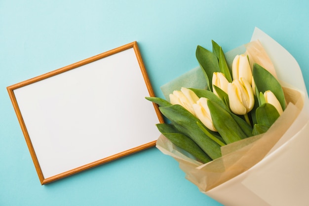 Bouquet and frame on blue