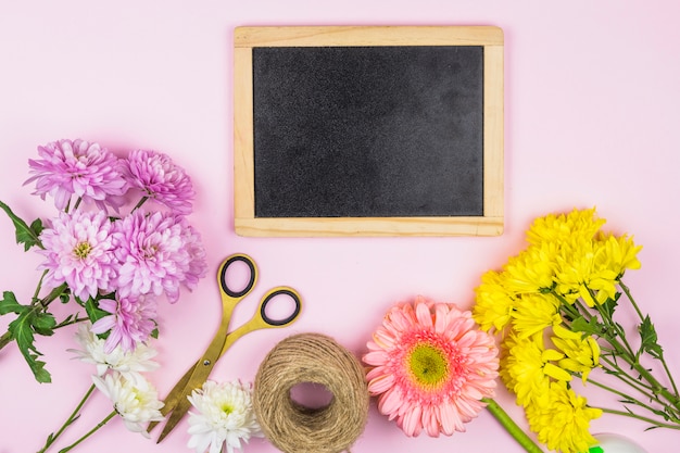 Free photo bouquet of fresh flowers near scissors and photo frame