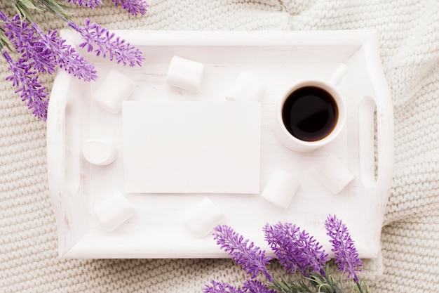 Bouquet of lavender and cup of coffee in bed