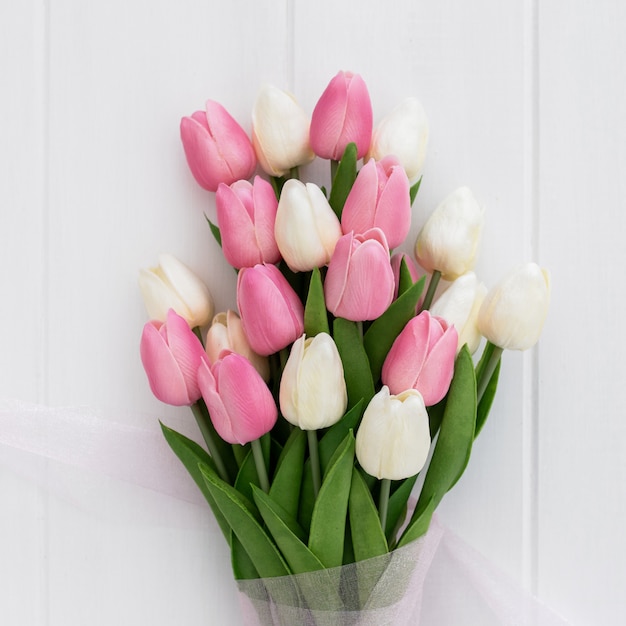 Free Photo bouquet of pretty pink and white tulips on wooden background