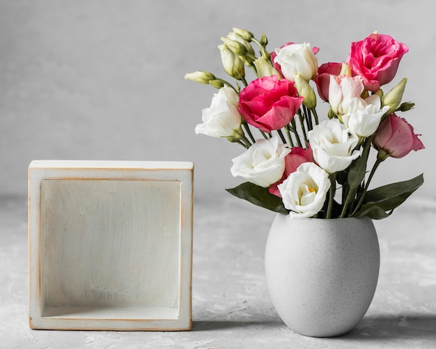 Bouquet of roses next to an empty frame