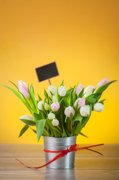 Free photo bouquet of tulips in rustical pot