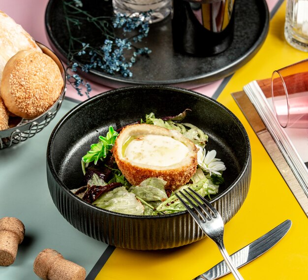 bowl of breaded chicken filled with cheese and lettuce