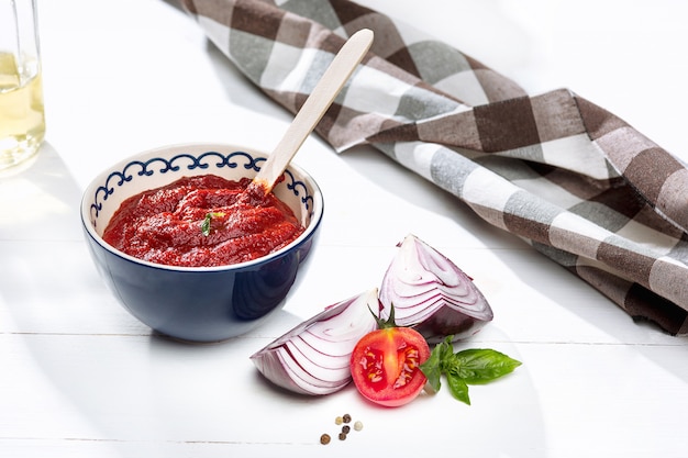 Free Photo bowl of chopped tomatoes on rustic table