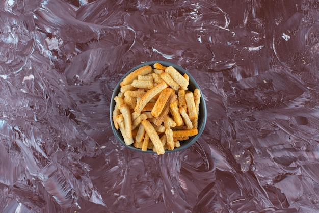 A bowl of crispy breadcrumbs on marble. 