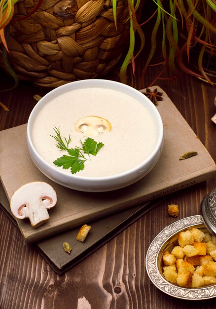 A bowl of delicious homemade cream of mushroom soup with roasted bread.