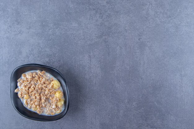 A bowl of delicious muesli, on the blue background. High quality photo