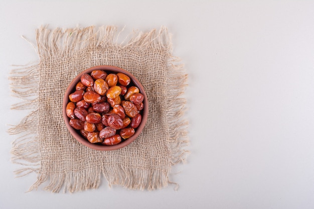 Bowl of dried delicious silverberries placed on white background. High quality photo