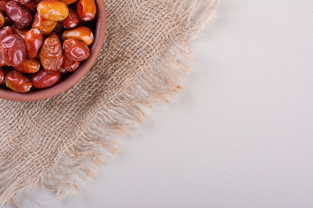 Bowl of dried delicious silverberries placed on white background. High quality photo