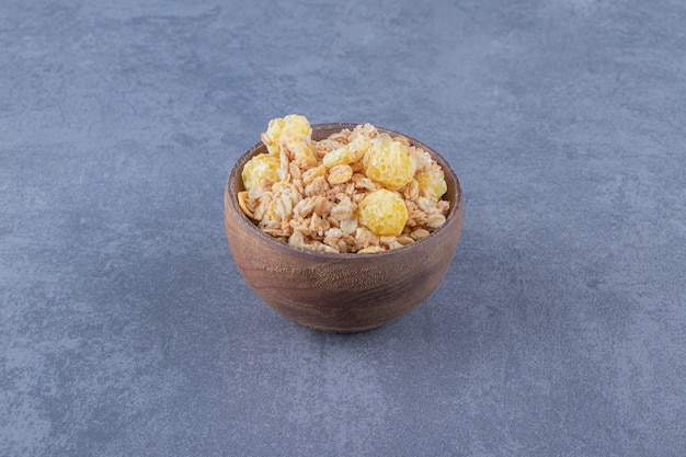 A bowl of flavorful muesli , on the marble background.