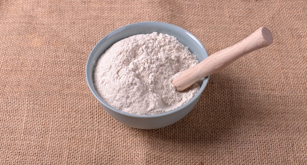 A bowl of flour on tablecloth