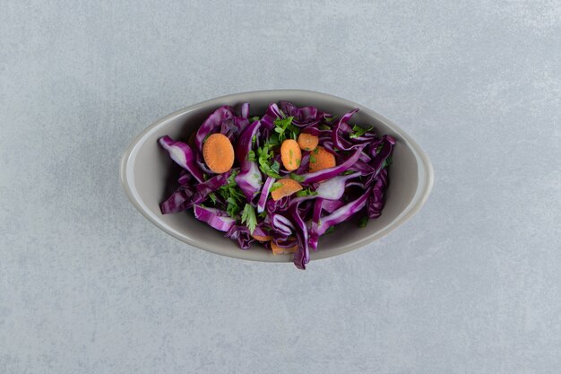 A bowl of grated vegetables, on the marble background.