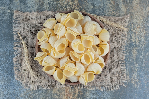 A bowl of mixed pasta , on the marble background.