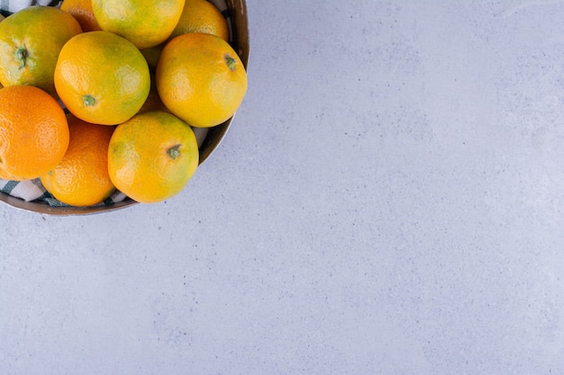 Bowl of tangerines on marble background. High quality photo