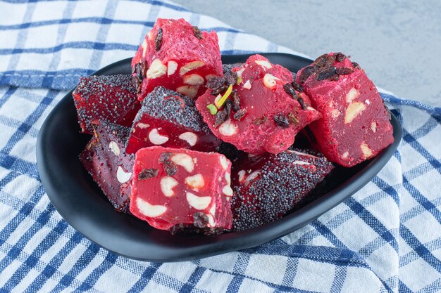 A bowl of Turkish delights, on the tea towel , on the marble table. 