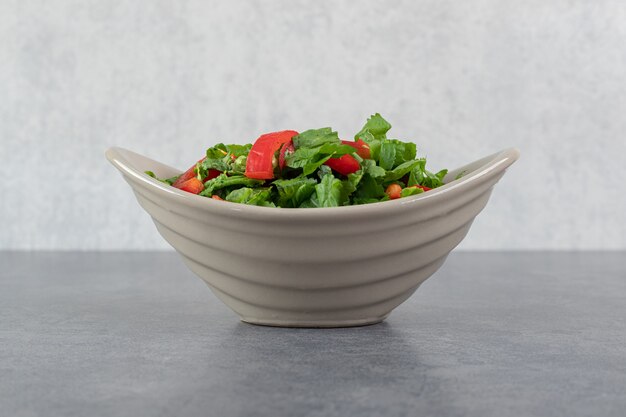 Bowl of vegetable salad on marble background. High quality photo