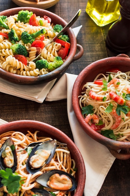 Bowl of vegetarian and non vegetarian pasta on wooden table