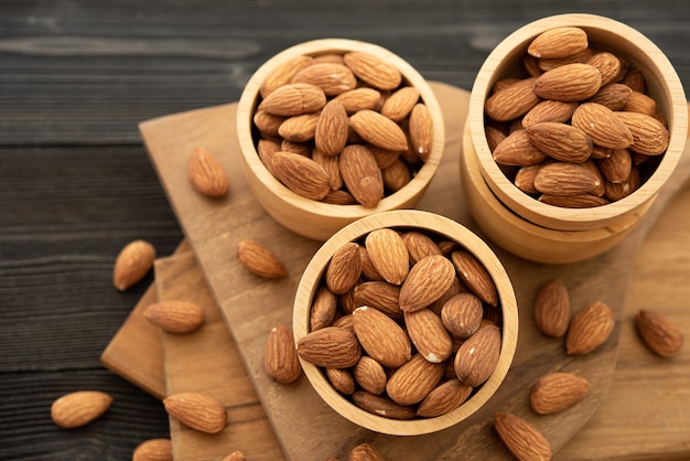 Free photo bowl with almond on a wooden table.