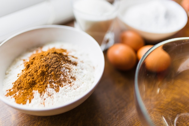 Bowl with flour near eggs