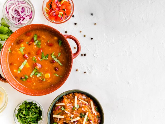 Bowl with garnish near cups of vegetables