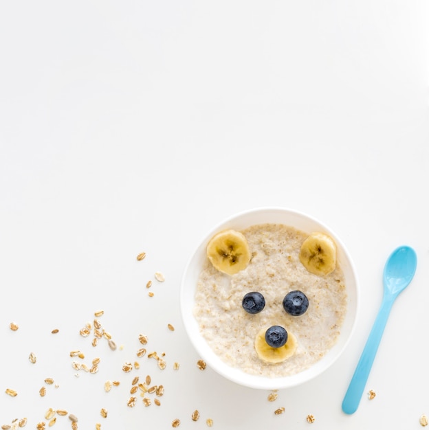 Bowl with oat flakes and fruits with copy-space