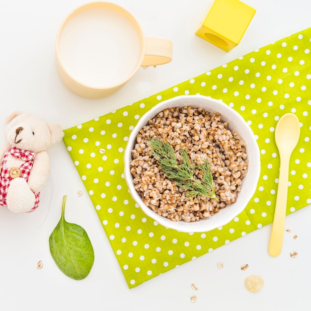 Bowl with oat flakes and glass of milk