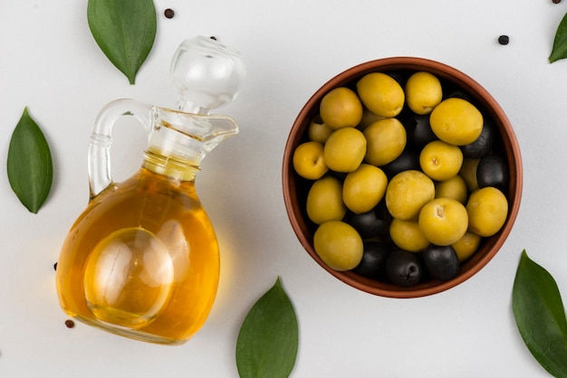 Free photo bowl with olives and olives oil bottle