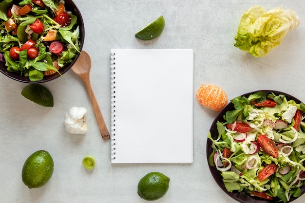 Bowl with salad and notebook