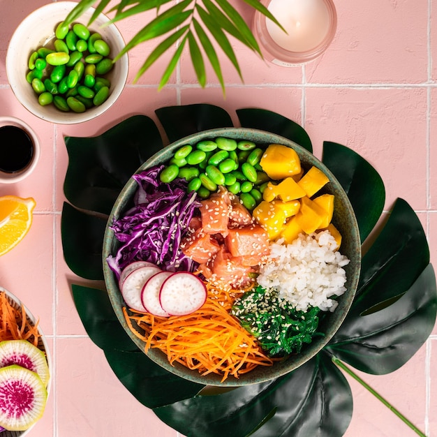 Bowl with salmon rice and fresh vegetables poke top view