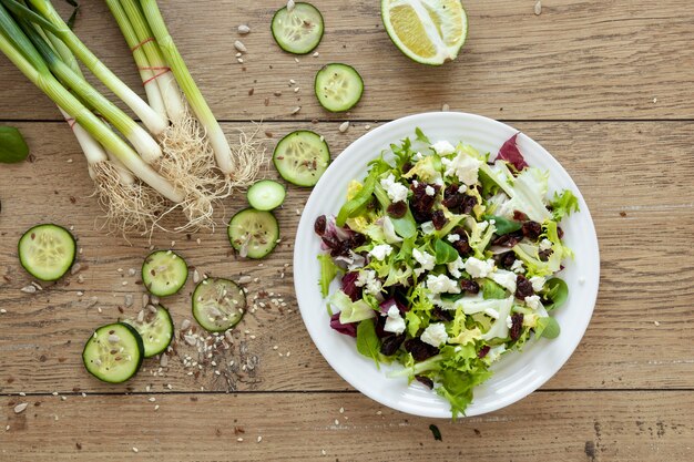 Bowl with vegetables salad on table