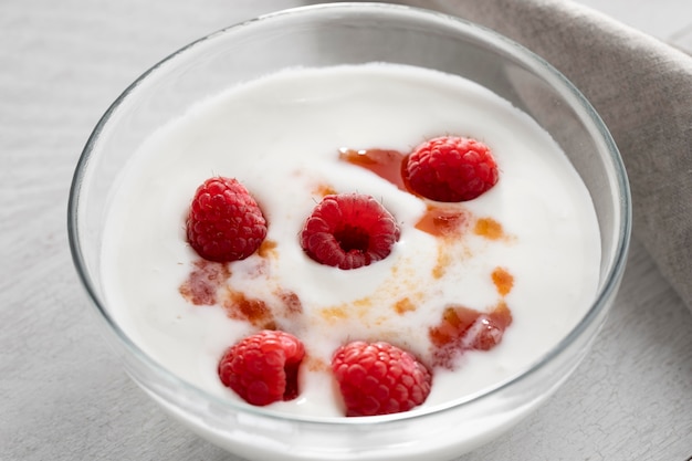 Bowl with yogurt and raspberries