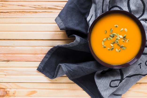 Bowl with yummy soup on towel