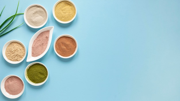 Bowls filled with coloured sand and leaves copy space