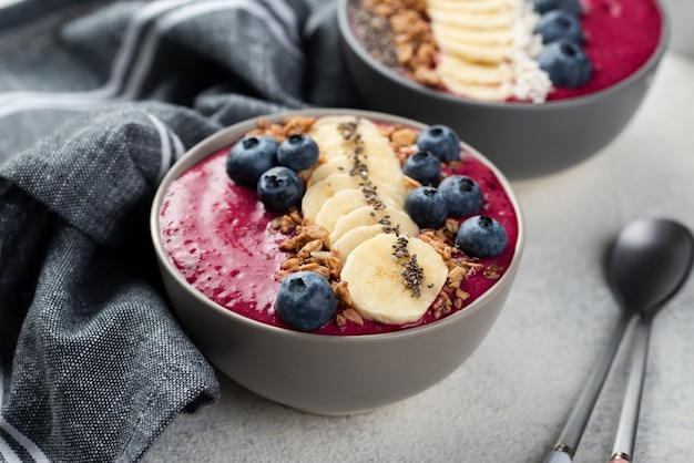 Bowls with breakfast desserts and blueberries