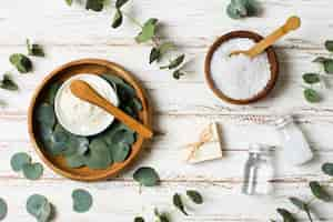 Free photo bowls with leaves and salt spa concept