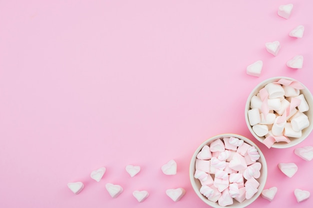 Free Photo bowls with meringue on pink background