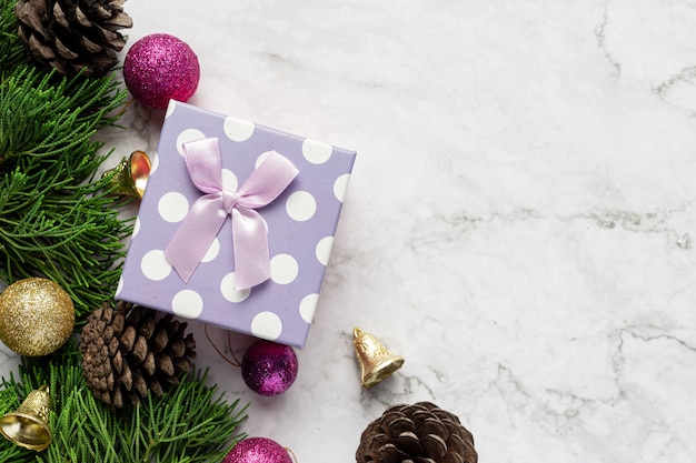 Box of present with Christmas ornament on marble background